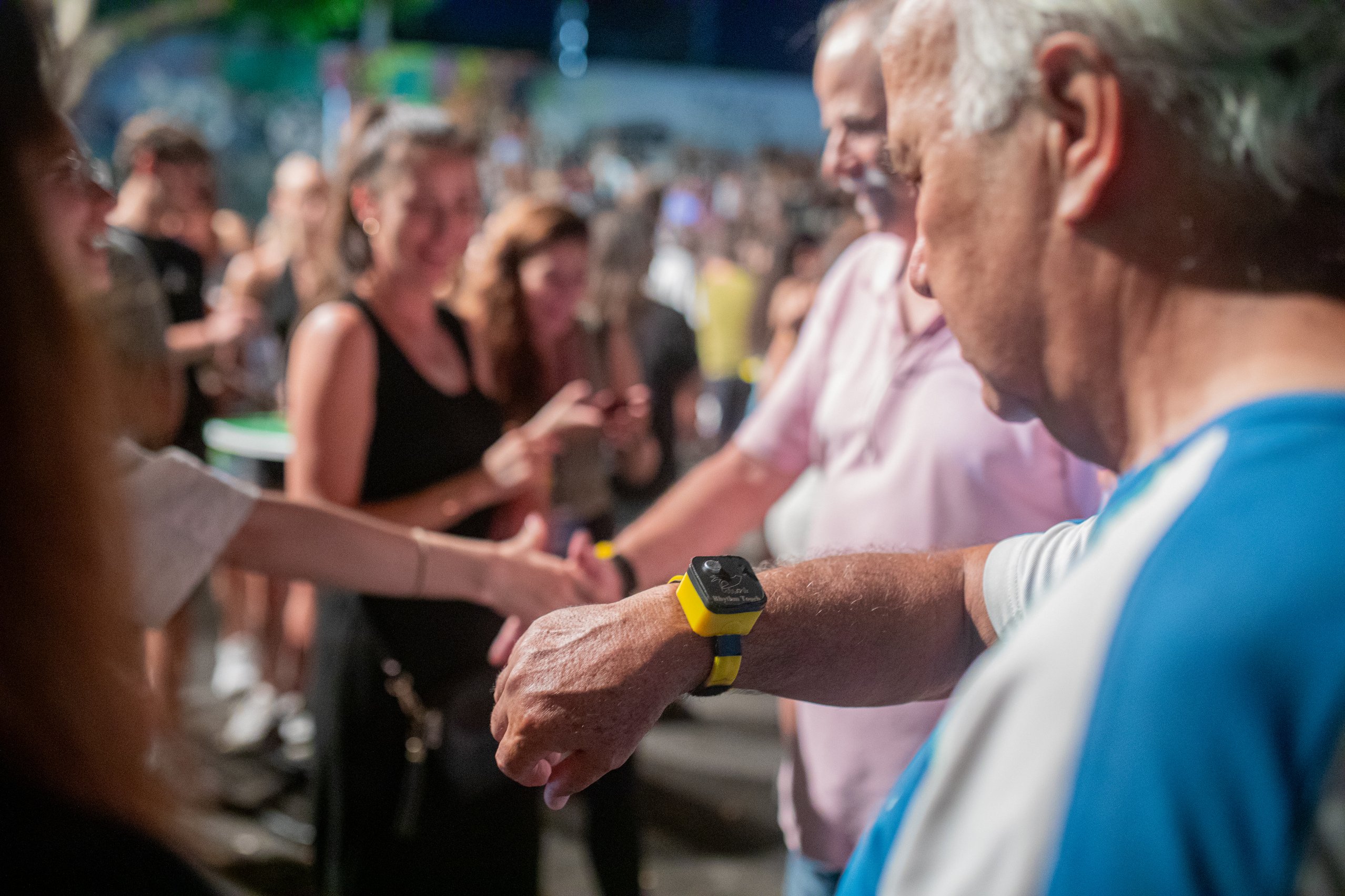 People showing the newly developed braclet on their arms