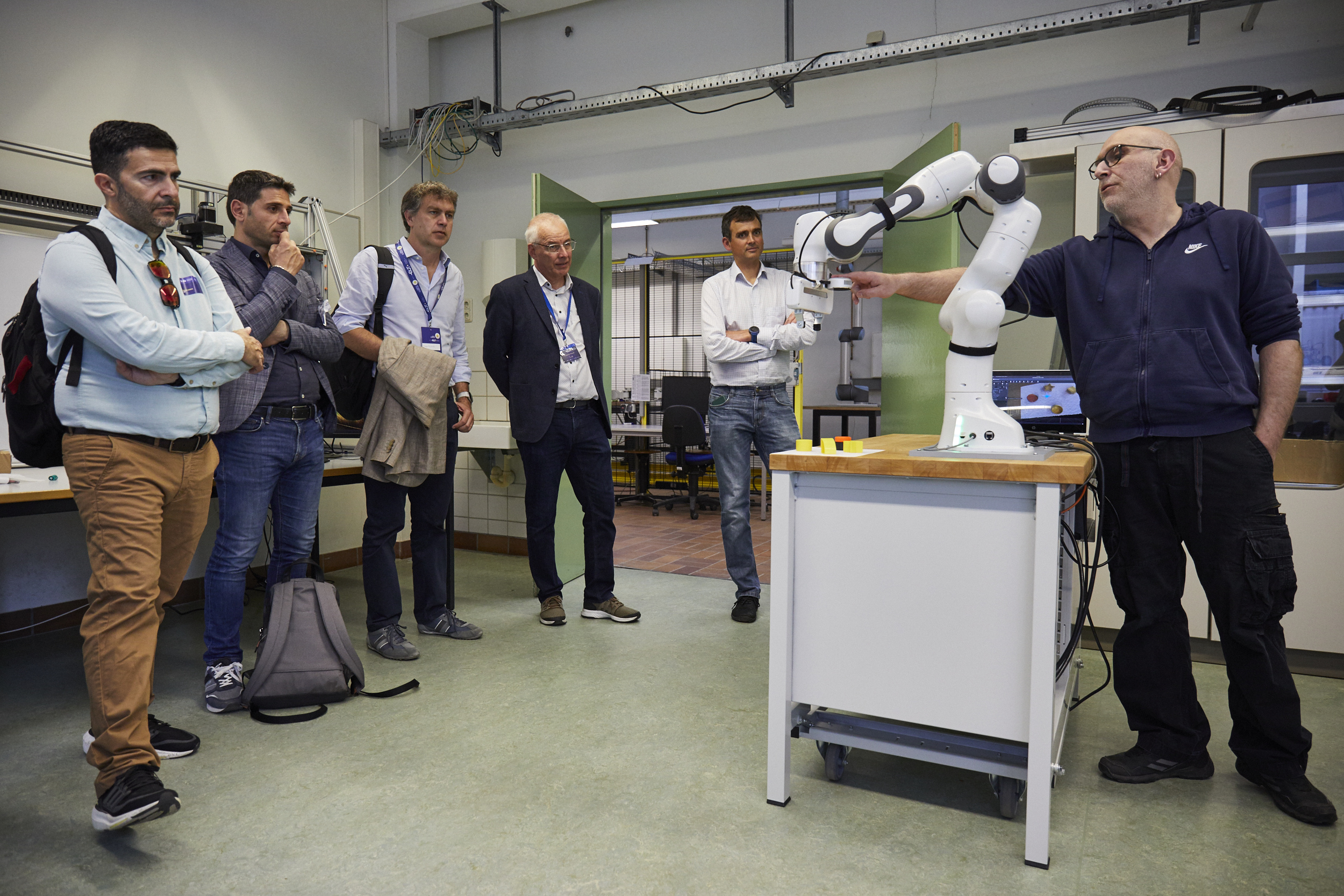 Wissenschaftler hält den Panda-Greifarm, Gruppe sieht zu